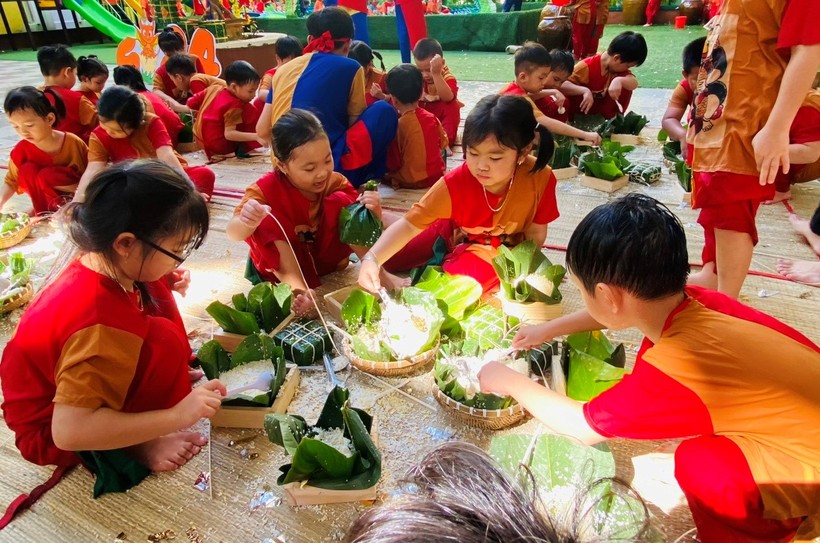 Trẻ trường mầm non Hoa Đào tham gia gói bánh chưng ngày Tết.